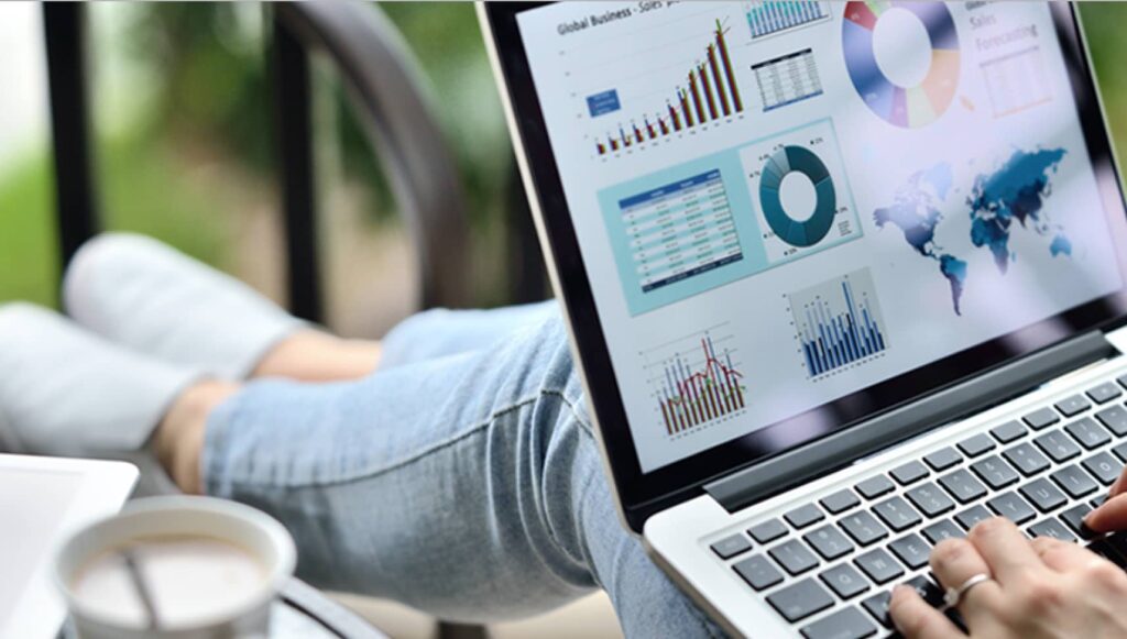 KPI's in Digital Marketing - Most Important. Women on computer with graphs