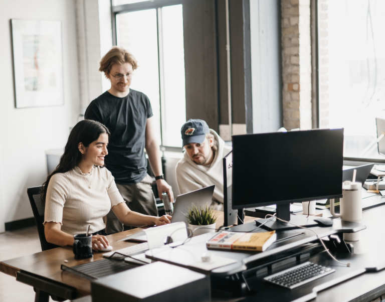 A collaborative team of marketers working together on a digital strategy, representing the comprehensive approach an electrician marketing agency takes to drive growth for electrical businesses