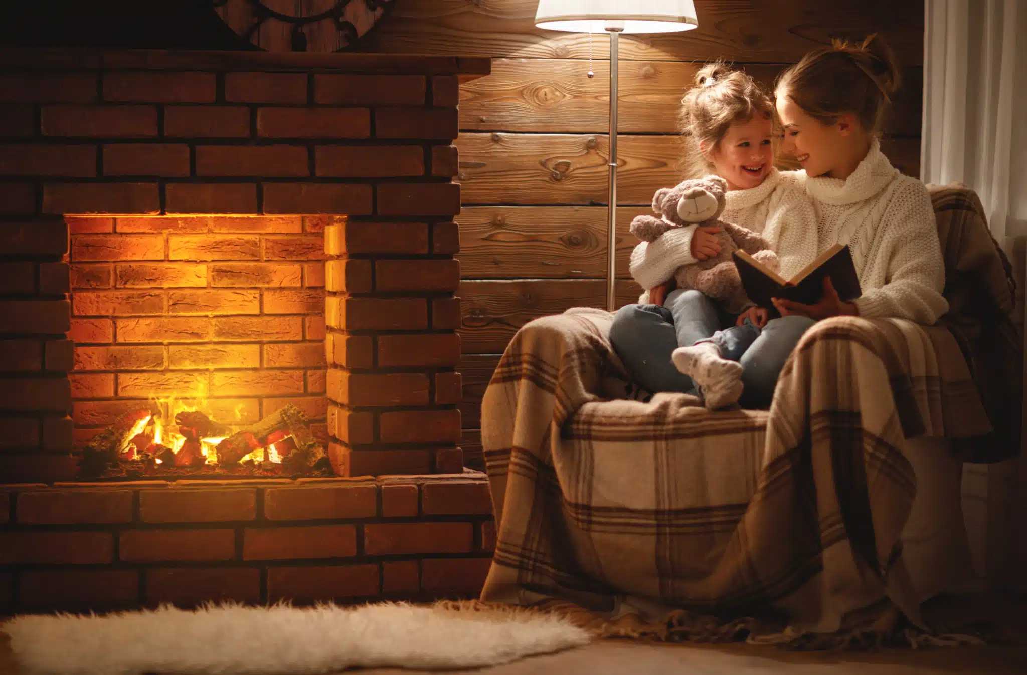 Mother and daughter in front of nice fireplace