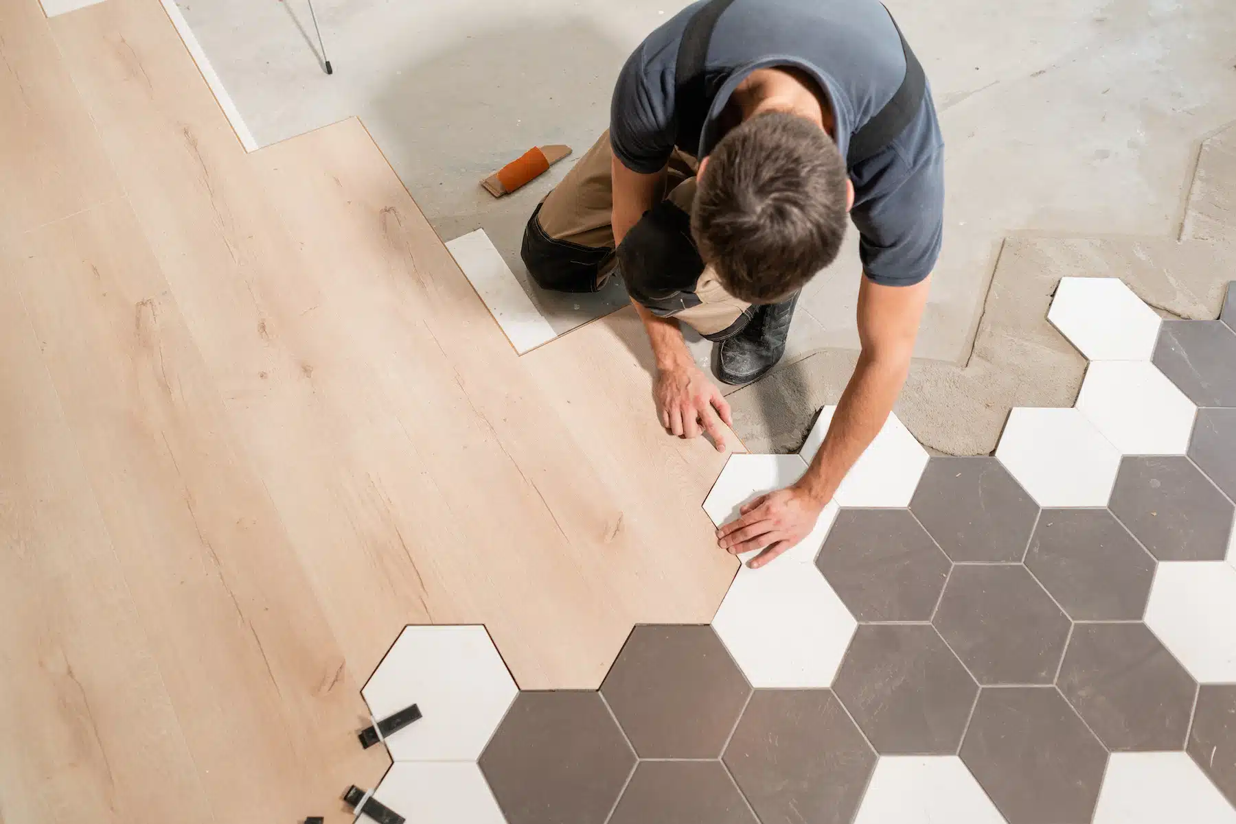 Skilled worker installing hardwood flooring, representing the craftsmanship of the flooring industry. A flooring website design agency helps flooring businesses showcase their work online, attract more customers, and generate leads through custom website design and digital marketing strategies.