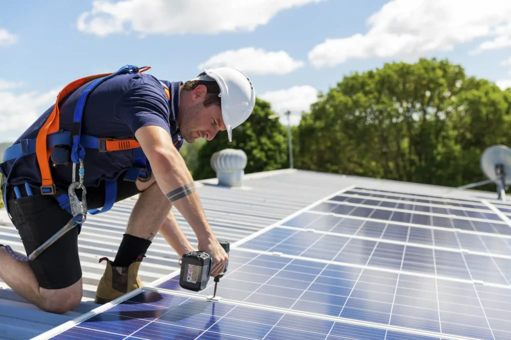 Technician installing solar panels on a residential roof, highlighting the craftsmanship and expertise that a solar marketing agency uses to promote residential solar services through custom website design and lead generation strategies.