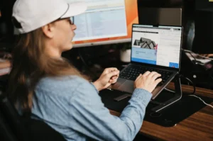Team member from our company working on a computer, demonstrating the expert web design process for home services businesses, focused on creating custom, user-friendly websites that drive customer engagement and lead generation.